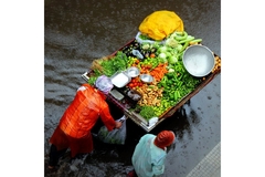People carrying food through floods.